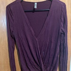Purple cross shirt. Buttons on the front 
Deep V